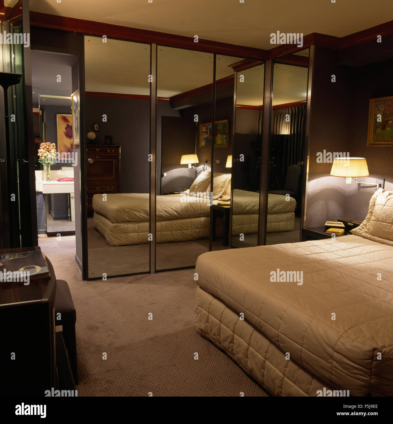 Mirrored Doors On Fitted Wardrobe In An Eighties Bedroom