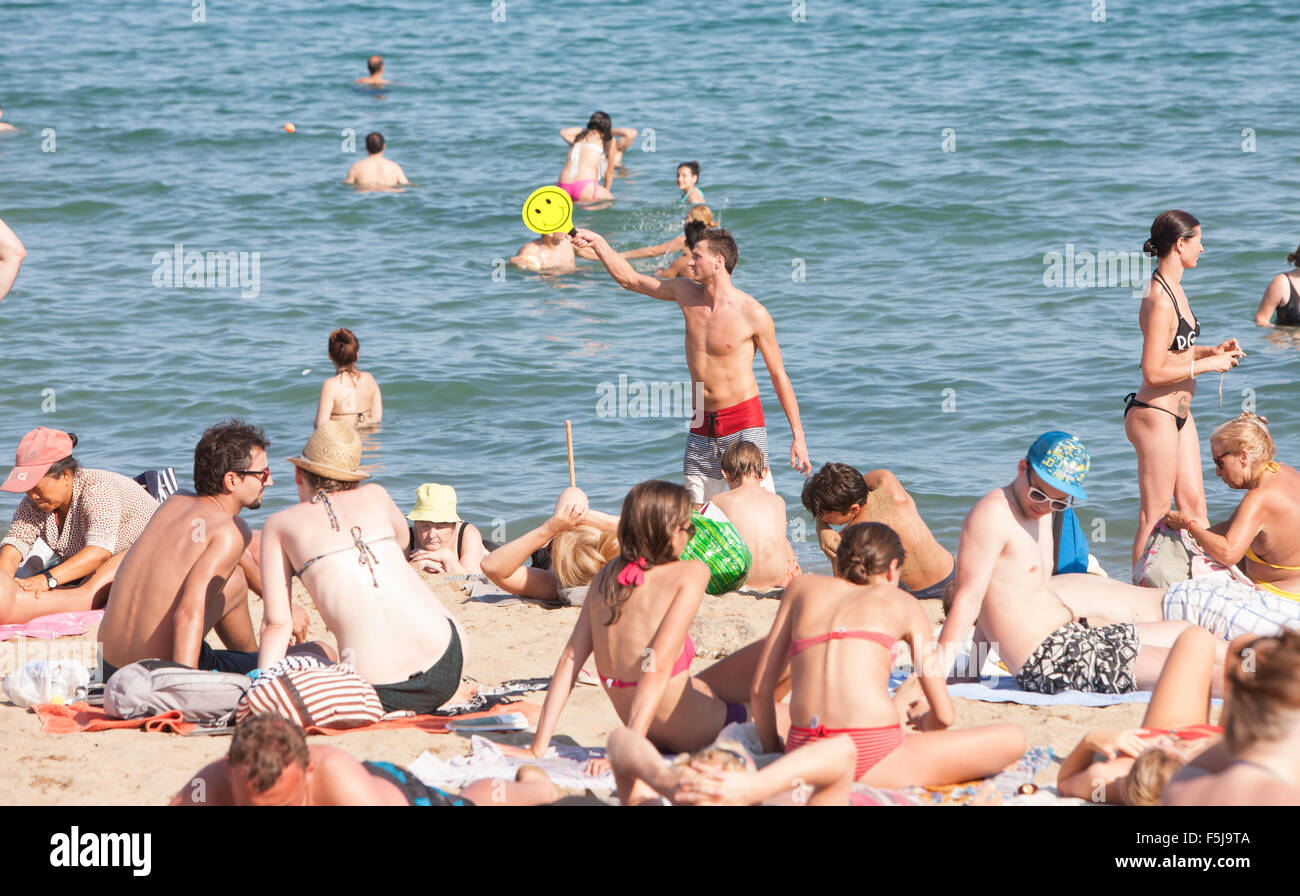 Sun bathing,swimming at urban beach, Barceloneta,Barcelona.warning,danger,sunburn,sun,burnt,beach,Catalonia,Spain. Stock Photo