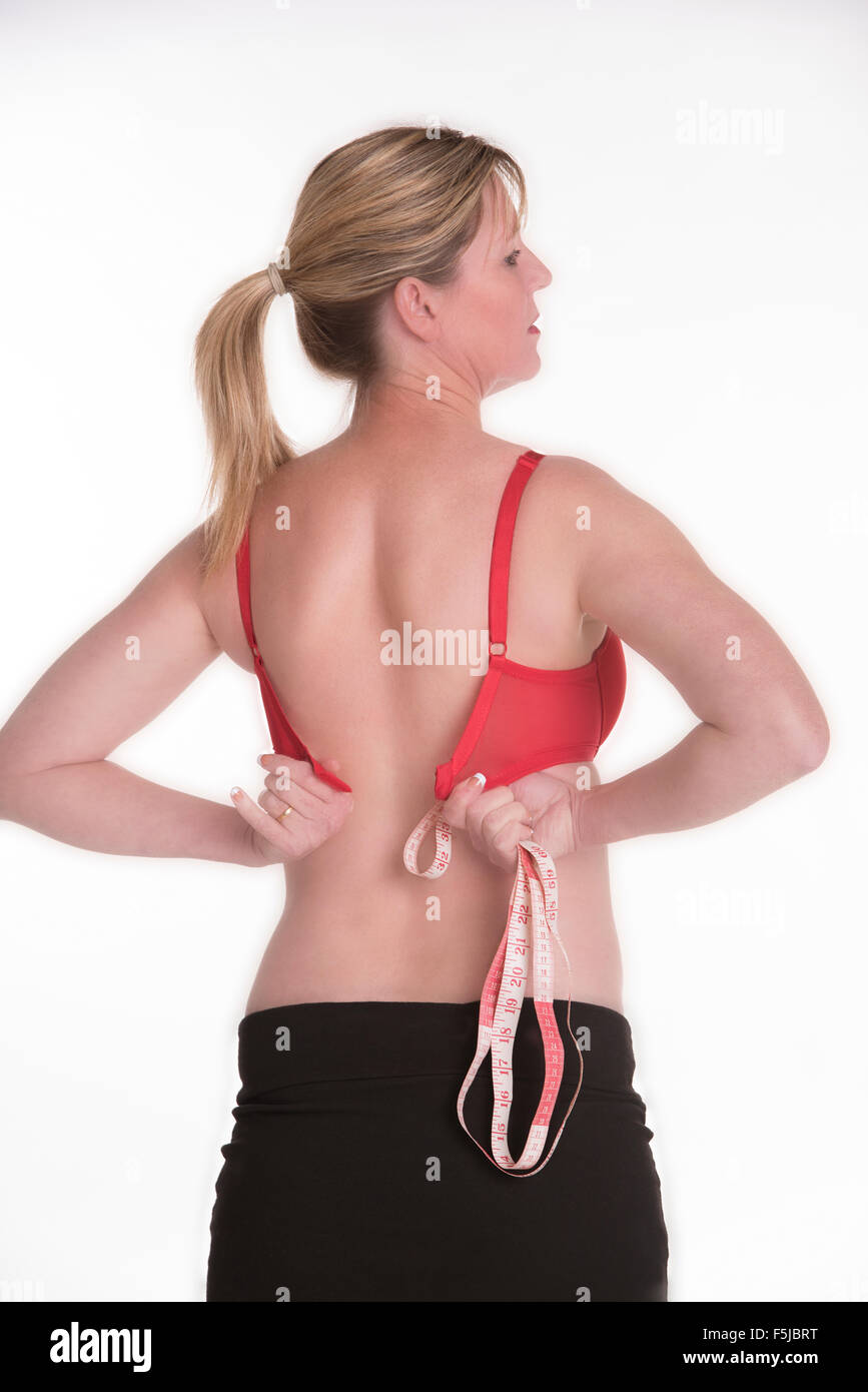 https://c8.alamy.com/comp/F5JBRT/woman-in-red-underwear-holding-a-tape-measure-as-she-fastens-her-bra-F5JBRT.jpg