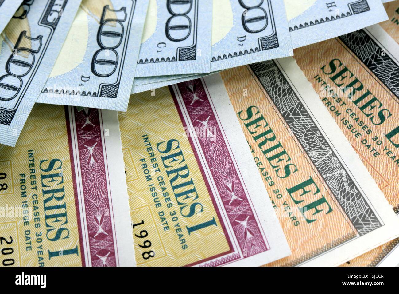 United States Savings Bonds with American Currency - Financial Security Stock Photo