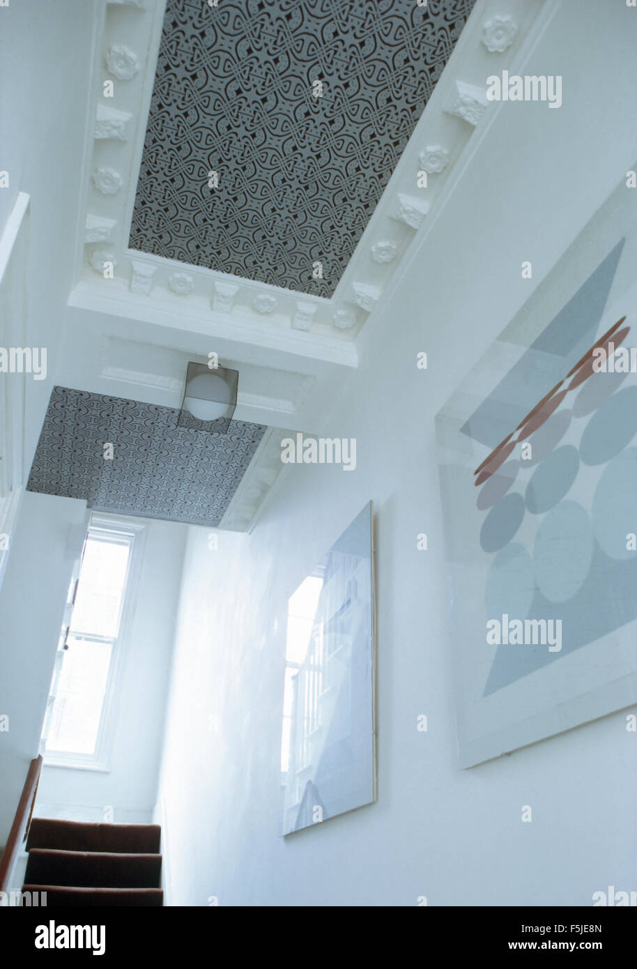 Patterned Wallpaper On Ceiling Panel With Ornate Plasterwork In A