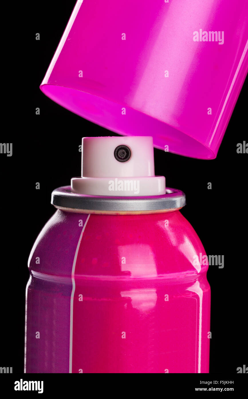 Pink spray aerosol over black closeup Stock Photo