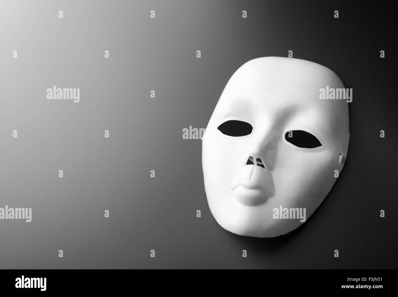 Macro of theater mask on grey background Stock Photo