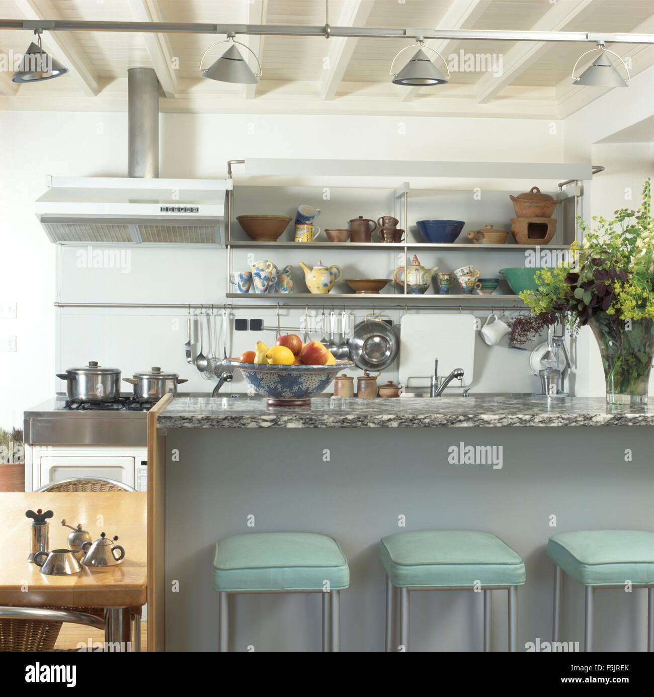 Pale turquoise leather+chrome stools at breakfast bar in a modern kitchen Stock Photo Alamy