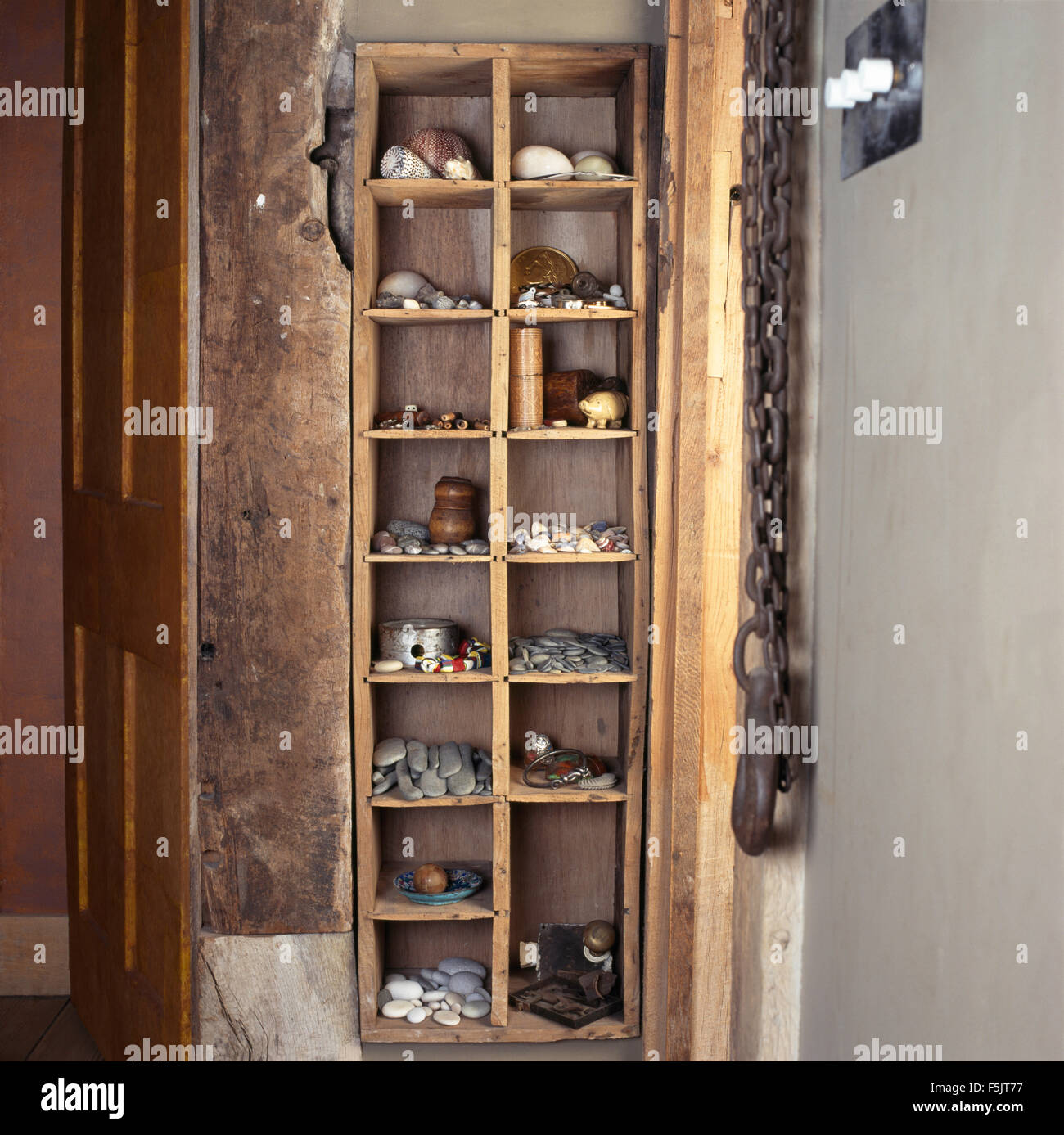 https://c8.alamy.com/comp/F5JT77/collection-of-found-objects-on-narrow-rustic-wooden-cube-shelves-F5JT77.jpg