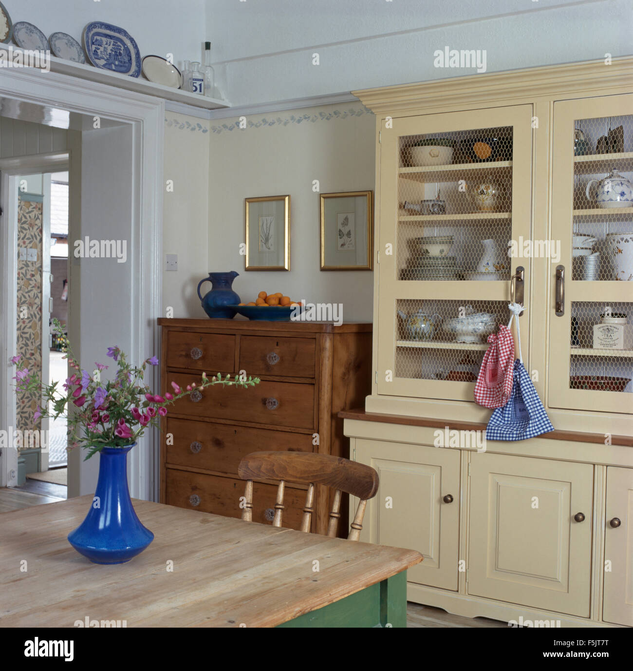 Cream Painted Dresser And Old Pine Chest Of Drawers In A Country
