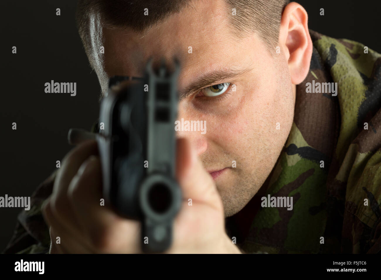 Soldier with rifle AK-47 aiming to you Stock Photo