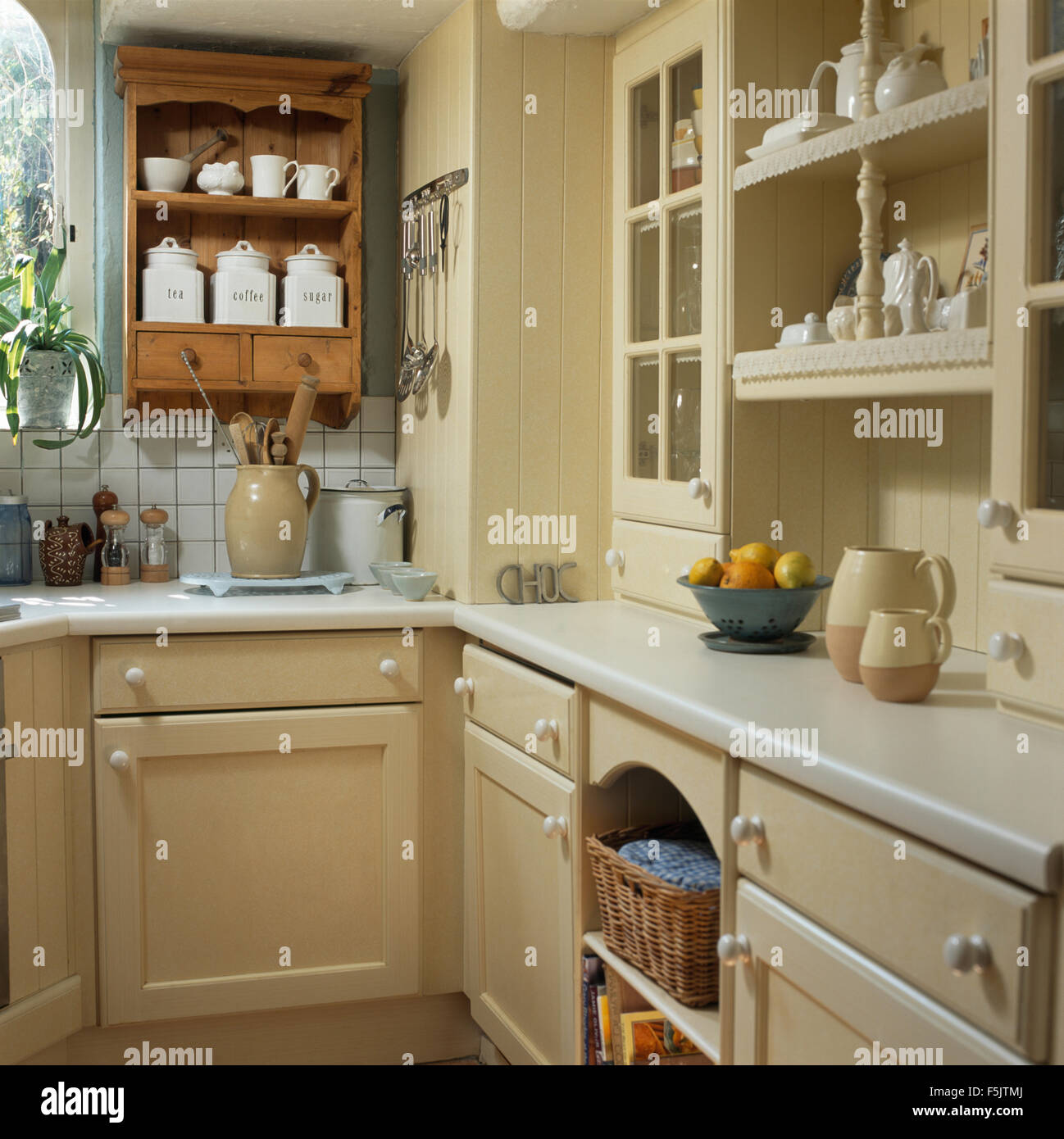 https://c8.alamy.com/comp/F5JTMJ/small-pine-wall-unit-with-white-ceramic-storage-jars-in-a-cream-country-F5JTMJ.jpg