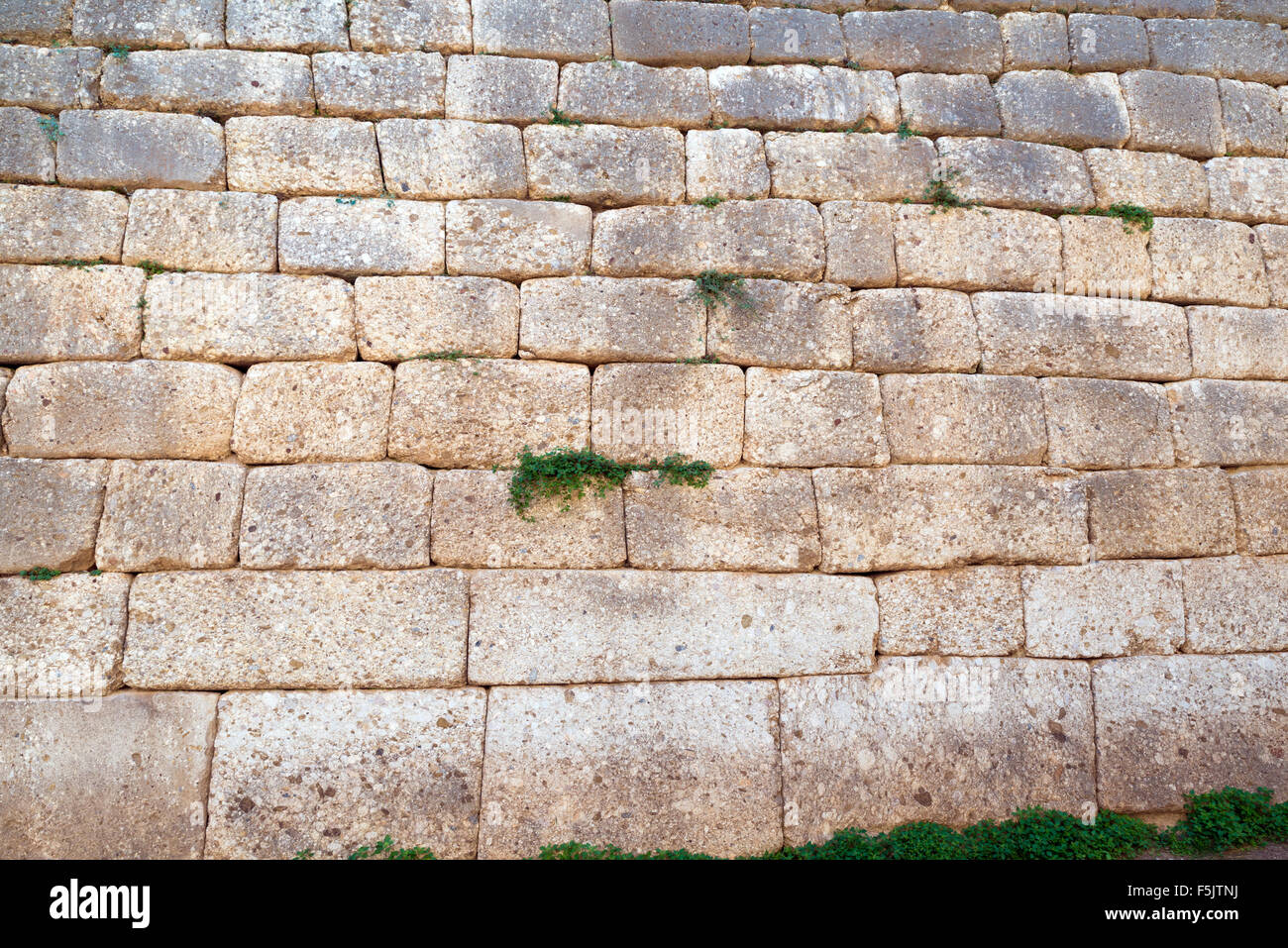 Cyclopean wall of The Treasury of Atreus or Tomb of Agamemnon at ancient Mycenae characterized by the use of massive stones of i Stock Photo