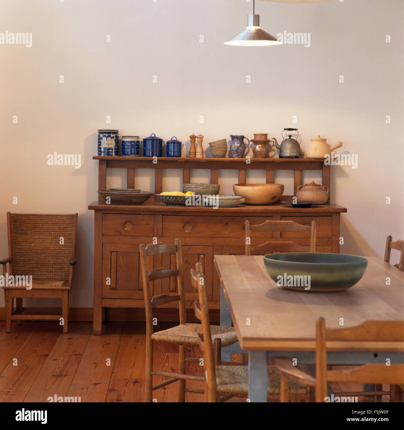 Vintage kettle and pottery on an Arts and Crafts sideboard with ladder