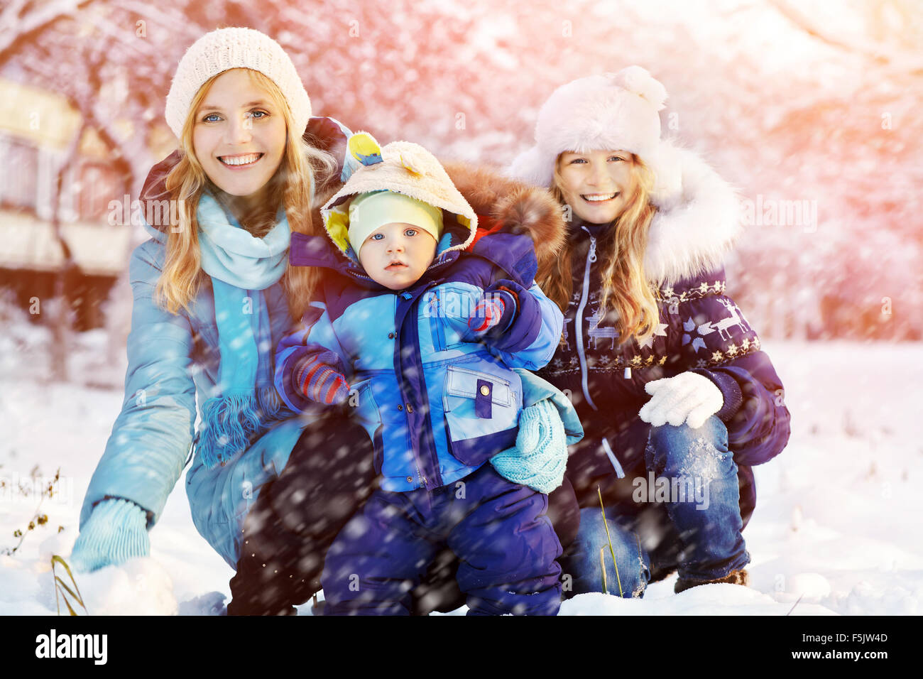 happy mother and children in winter park Stock Photo