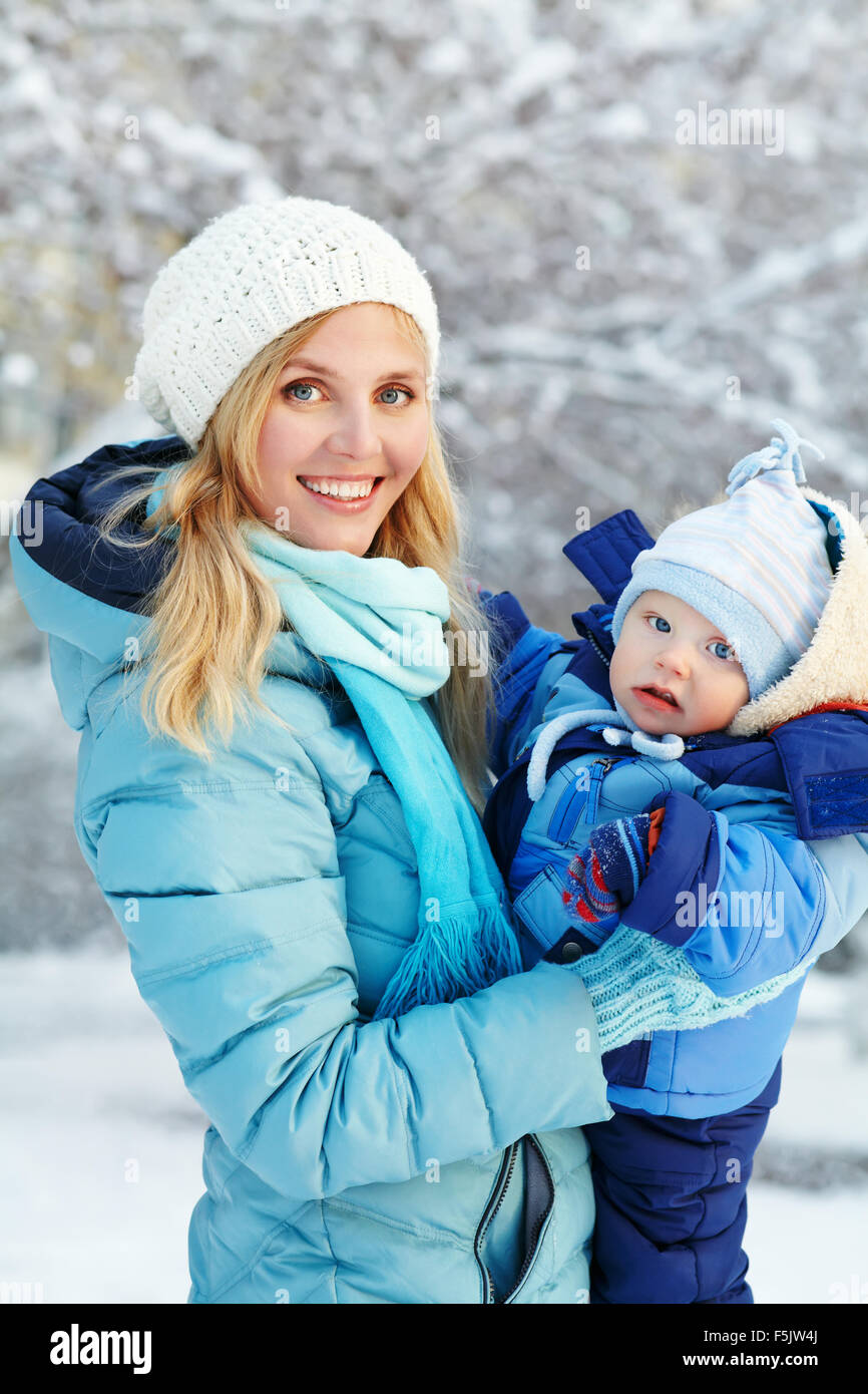 happy mother and baby in winter park Stock Photo