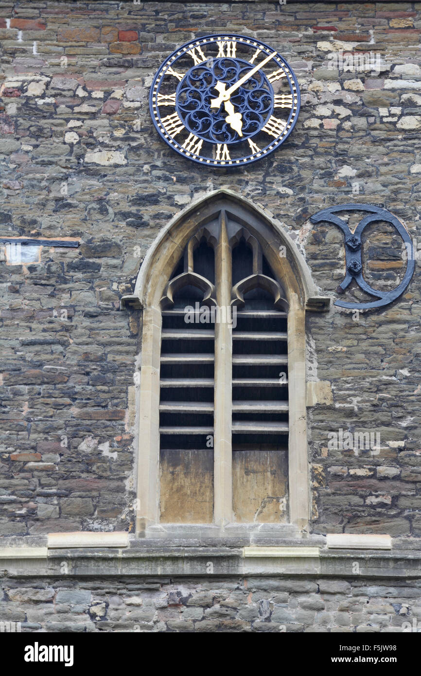 Very old church building with weathered stone slatted window and clock ...