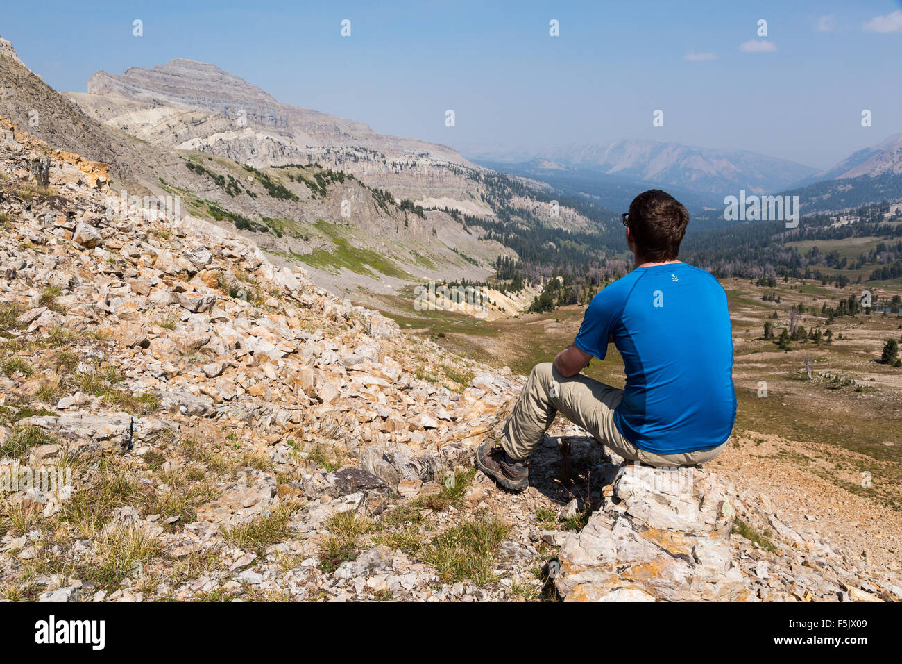 A hiker overlooking the headwaters of Crystal Creek in the Gros Ventre Wilderness, Wyoming Stock Photo