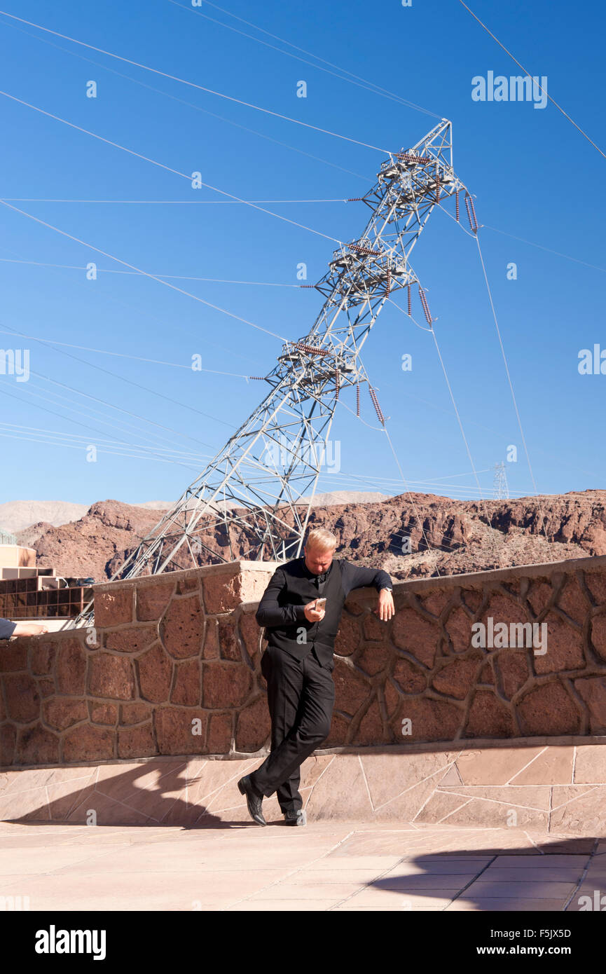 Man consulting his smartphone. Hoover Dam, Nevada, USA. Stock Photo