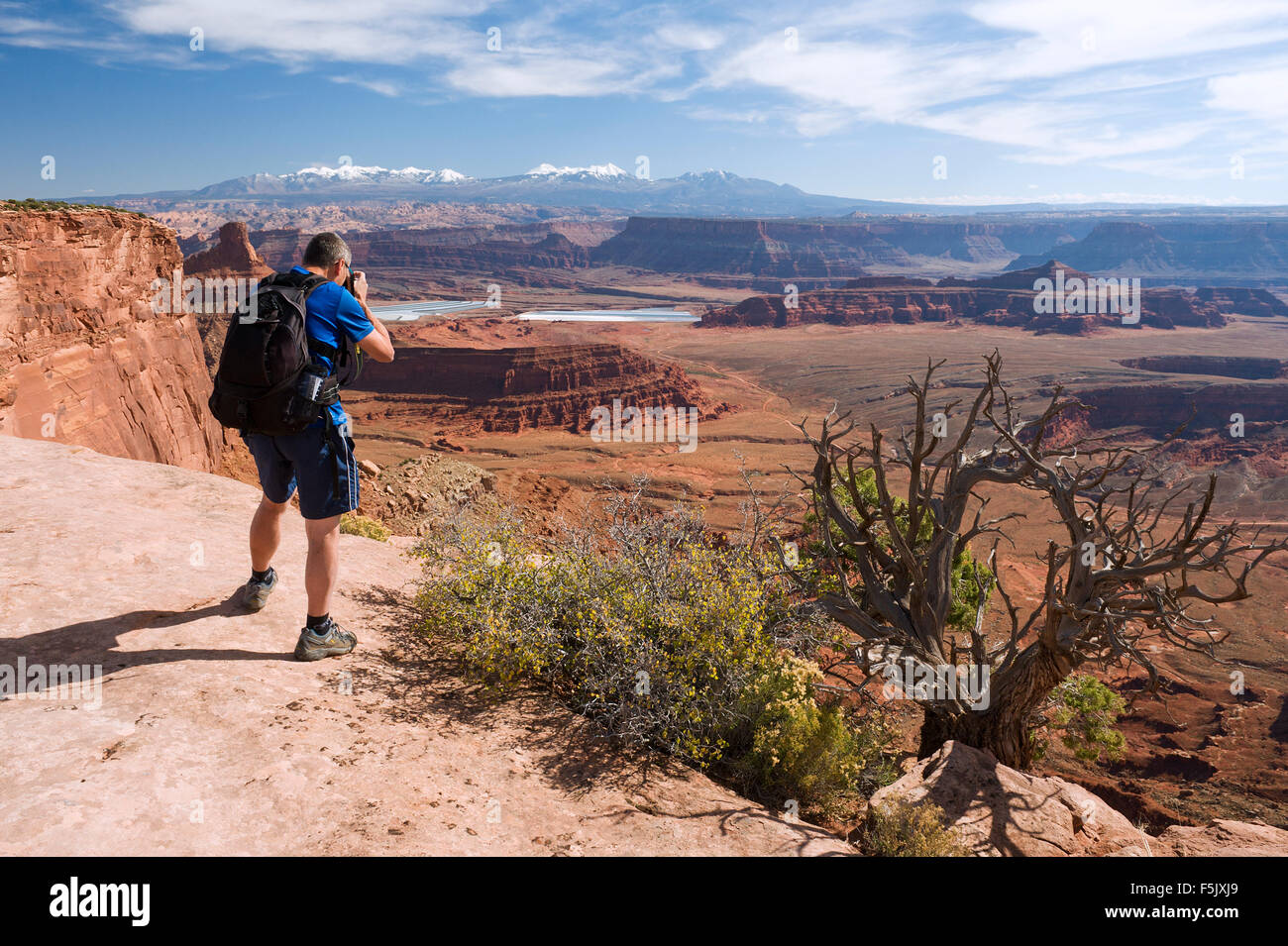 Hiker taking a picture from an overlook at Dead Horse Point State Park, Utah, USA. Stock Photo