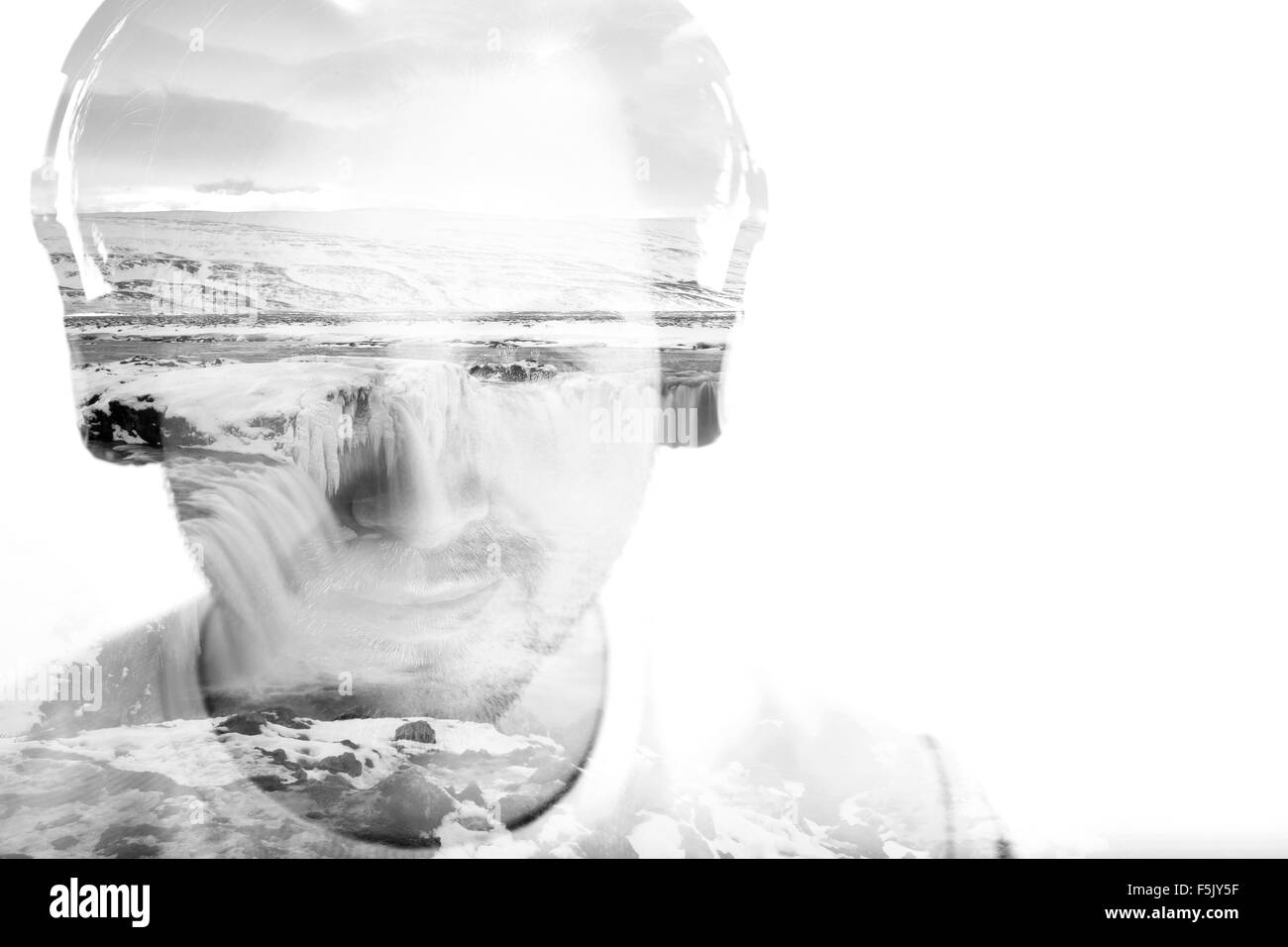 Young man with headphones and waterfall, double exposure, black and white Stock Photo