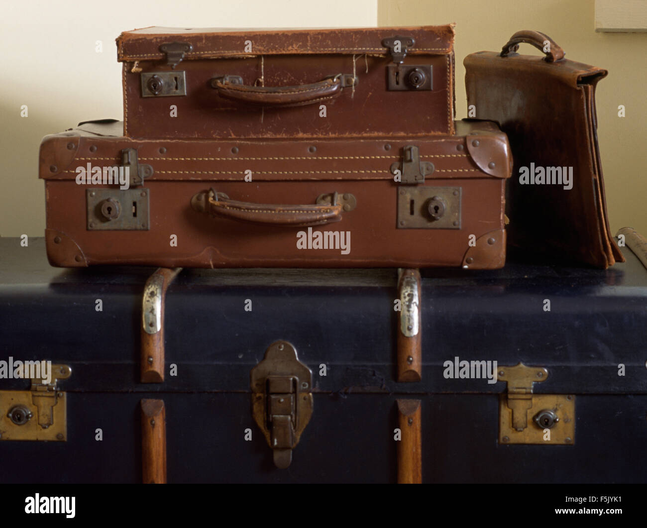 Close-up of a stack of vintage leather suitcases and a large old trunk Stock Photo