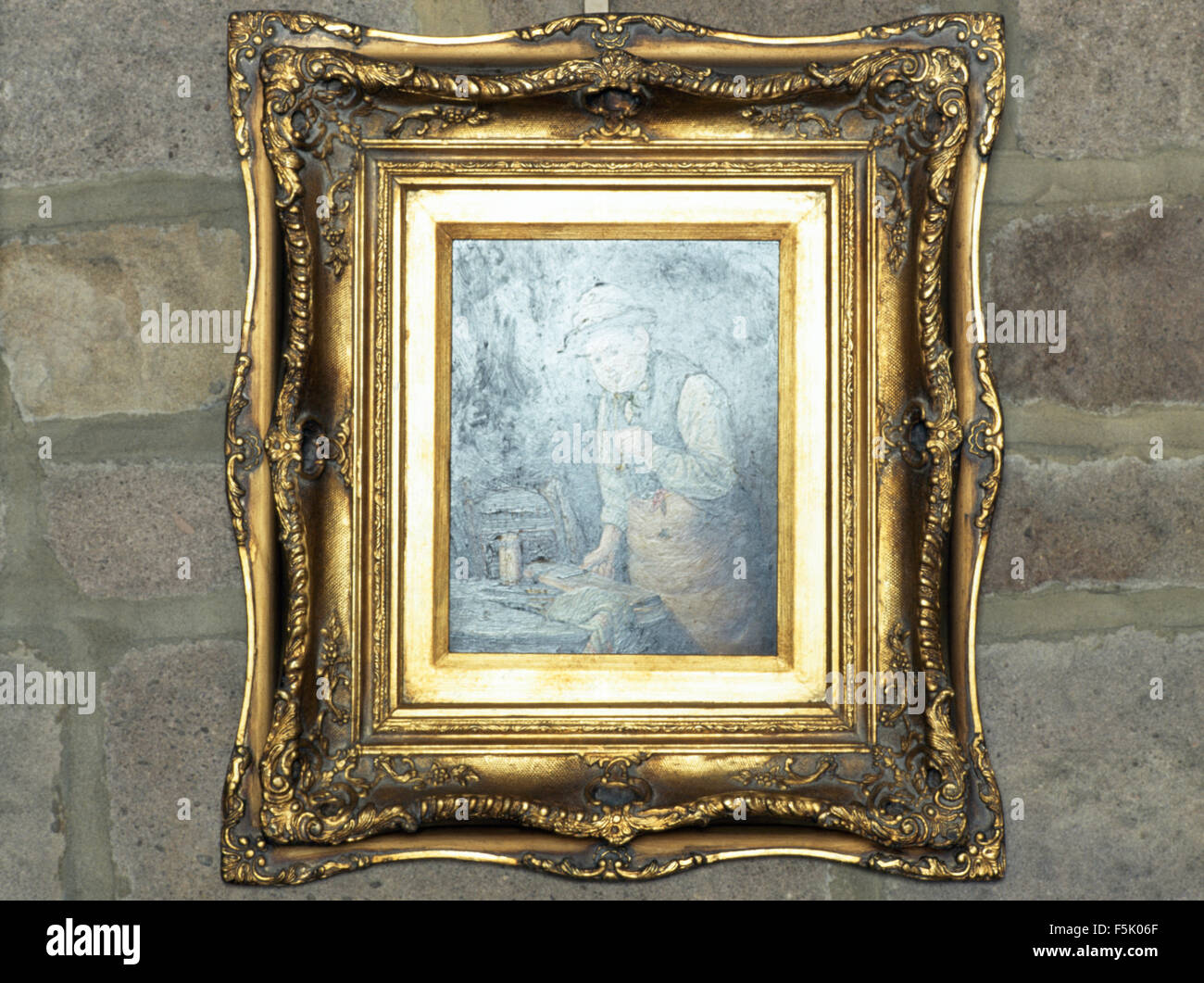 Closeup of a gilt framed vintage painting of an 18th century man Stock