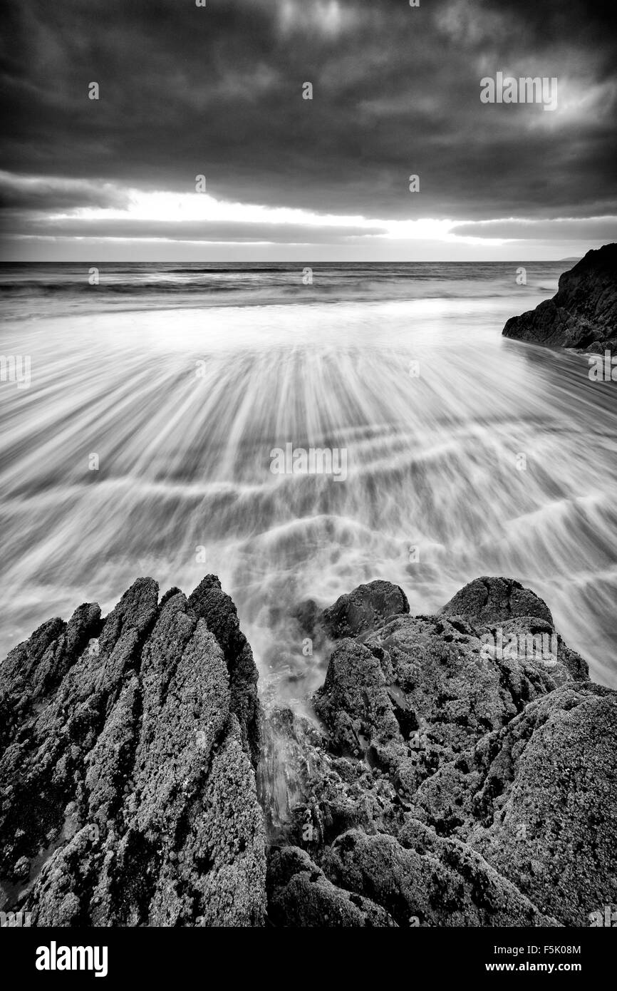 Storm Clouds over a  receding tide at  Freathy Beach Whitsand Bay Cornwall UK Stock Photo
