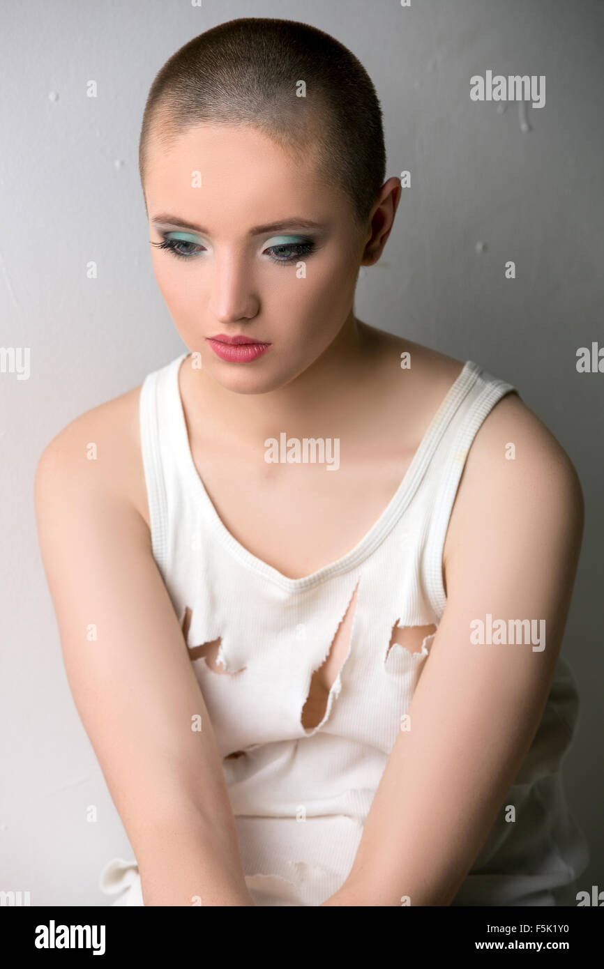 Image of beautiful skinhead girl in ragged t-shirt Stock Photo