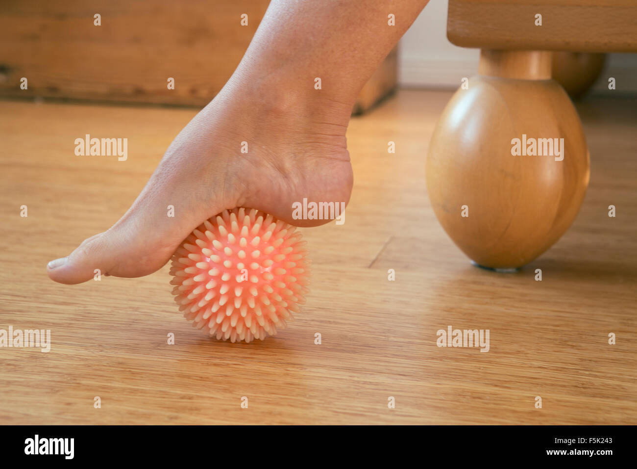 foot in with rubber massage ball Stock Photo