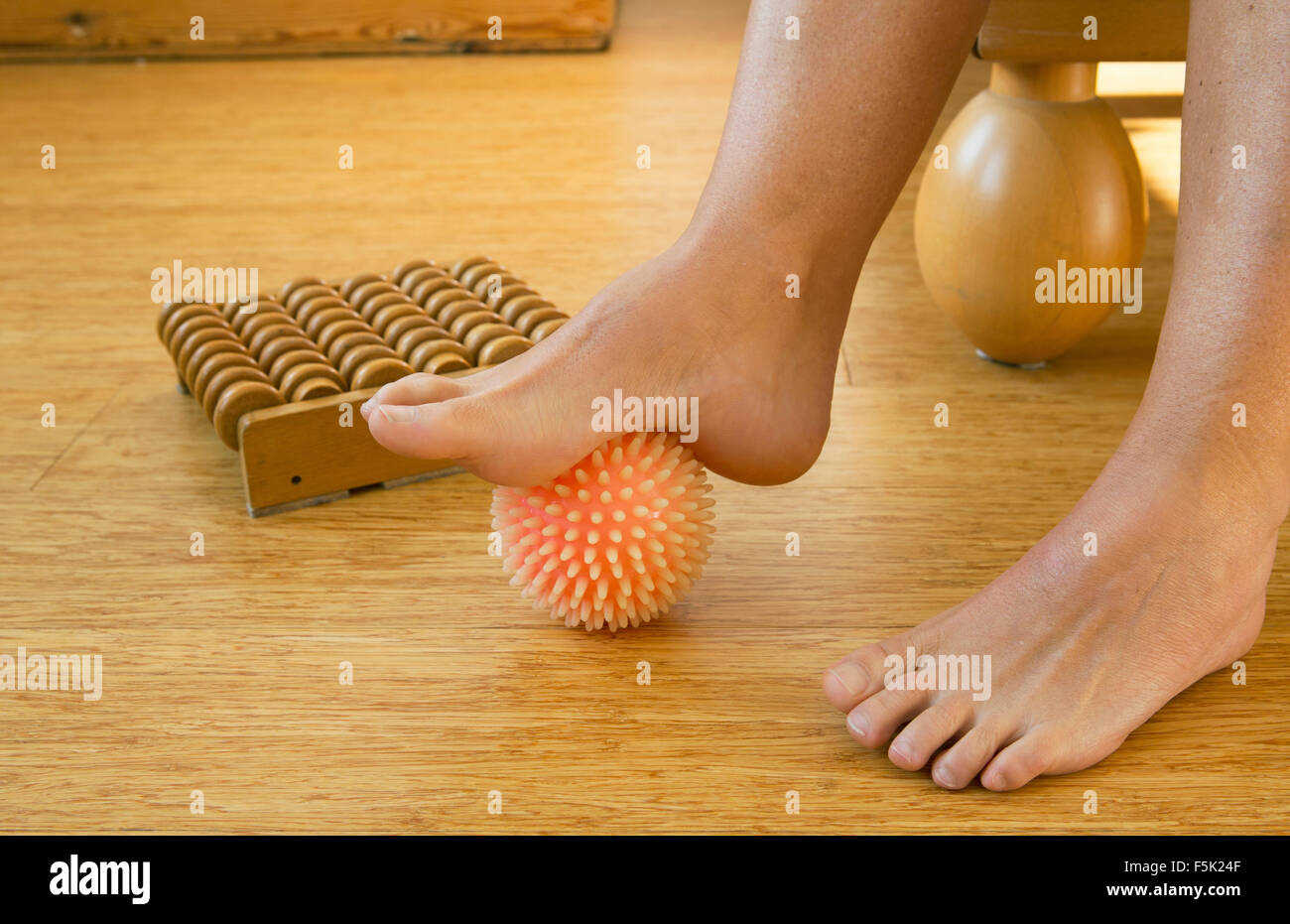 foot in with rubber massage ball Stock Photo