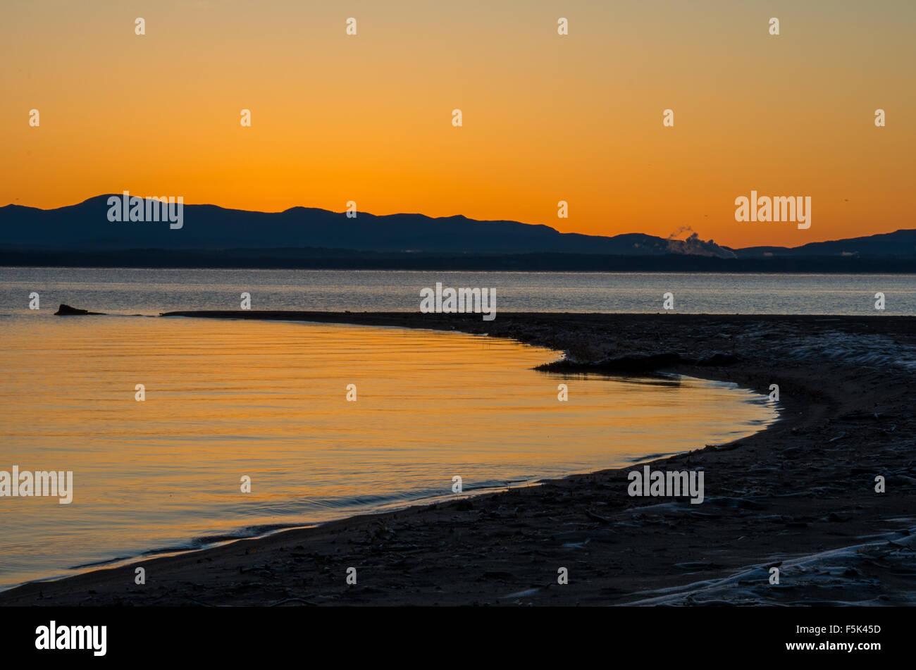 The sun coming up across Lake Champlain Stock Photo