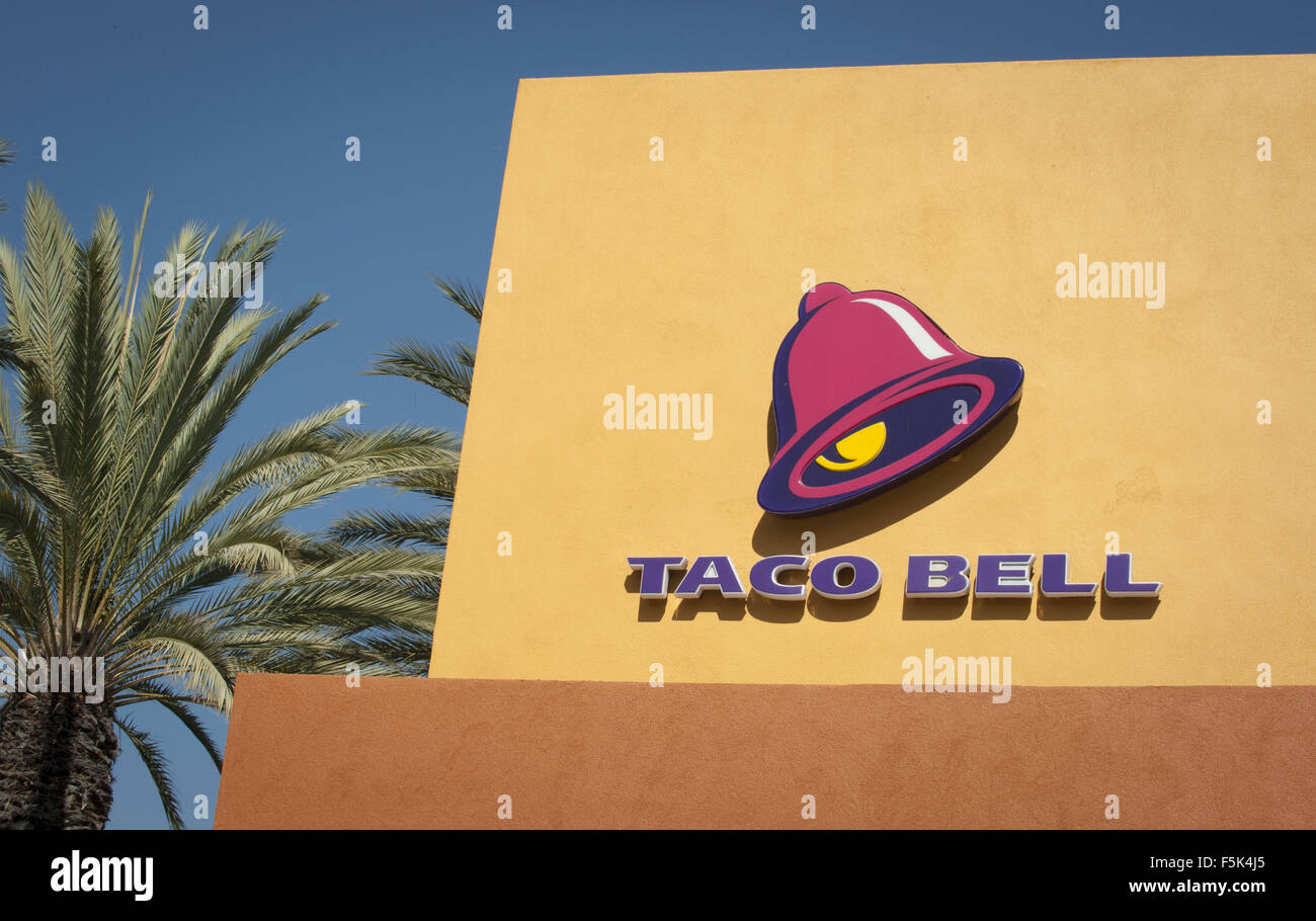 Tustin, California, USA. 27th Oct, 2011. Taco Bell is an American fast food chain of restaurants featuring traditional Mexican food like burritos, tacos, tostadas, quesdallas and other specialties. The Irvine based company is operated under the Yum! Brands with more than 6,000 restaurants nationwide. While the logo has gone through several redesigns, this photos shows a stylized ringing bell at an angle in a fuchia color over large all capital purple lettering spelling out ''TACO BELL'' in bold sans serif font. Taco Bell is a privately held company with more than 75% of stores op Stock Photo