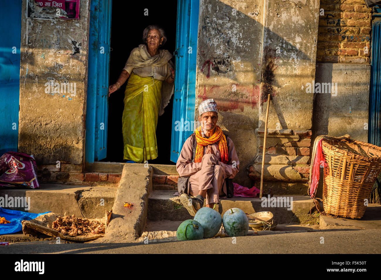 Old married couple in front of home in Kathmandu, Nepal Stock Photo
