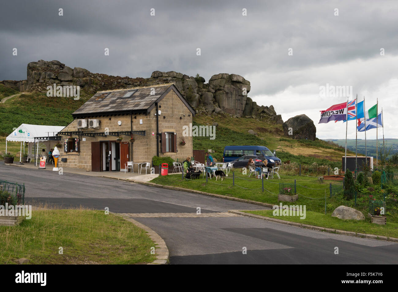 Dark grey clouds in sky over café & car park at the Cow and Calf Rocks, Ilkley, West Yorkshire, England, UK  - popular countryside visitor attraction. Stock Photo
