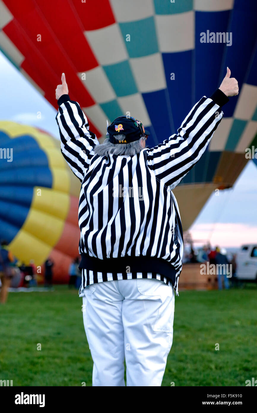 Female 'zebra' (launch director) giving two thumbs up, Albuquerque International Balloon Fiesta, Albuquerque, New Mexico USA Stock Photo