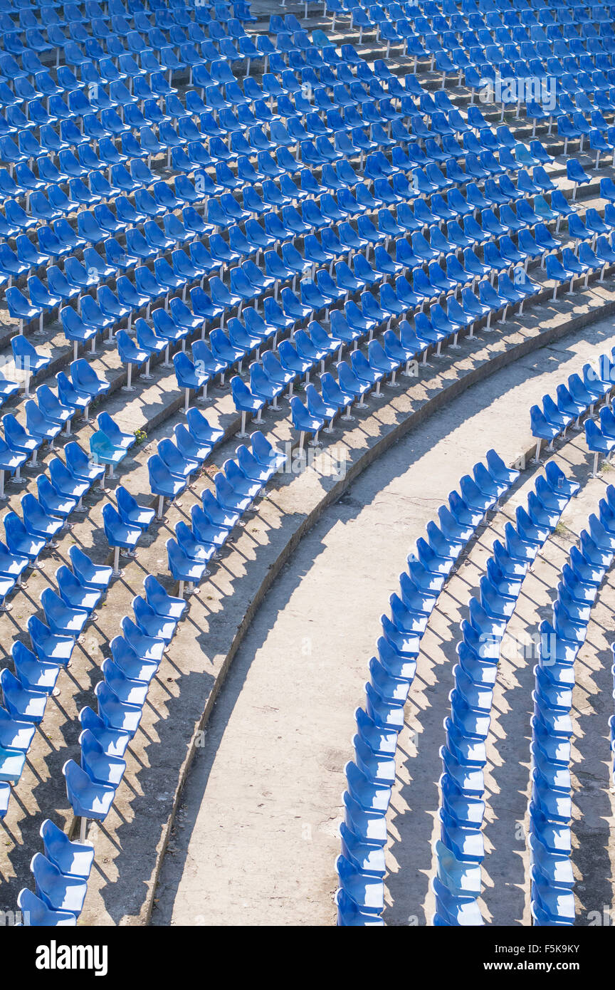 Empty blue chairs in an empty amphitheater hall Stock Photo