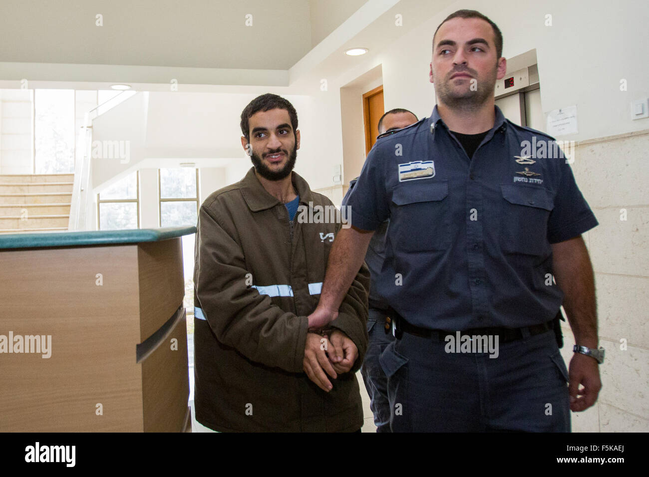 (151105) -- JERUSALEM, Nov. 5, 2015 (Xinhua) -- Abed al-Aziz Meri, 21, is escorted by Israeli prison officers at the District court in Jerusalem, on Nov. 5, 2015. Abed al-Aziz Meri was charged on Thursday morning with two counts of premeditated murder for instigating stabbing of Nehemia Lavi and Aharon Bennett in Jerusalem's Old City in last month. (Xinhua/JINI) Stock Photo