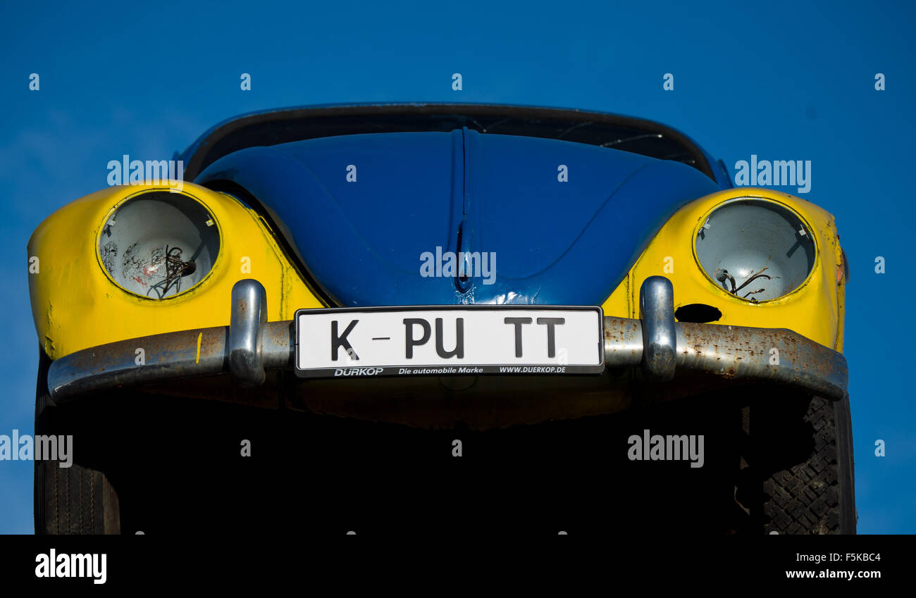 An old Volkswagen Beetle with the license plate 'K-PU TT' (kaputt - broken) can be seen on a forklift at a junk yard in Peine, Germany, 05 November 2015. Photo: JULIAN STRATENSCHULTE/dpa Stock Photo