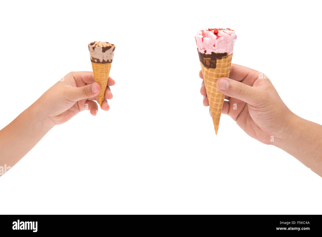boy holding a small ice cream cone and man holding a big one with clipping path Stock Photo