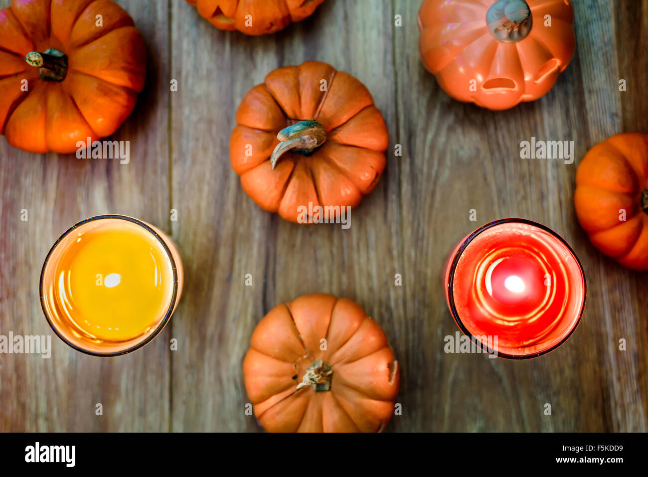 Pumpkins and Candles on the wooden background Stock Photo