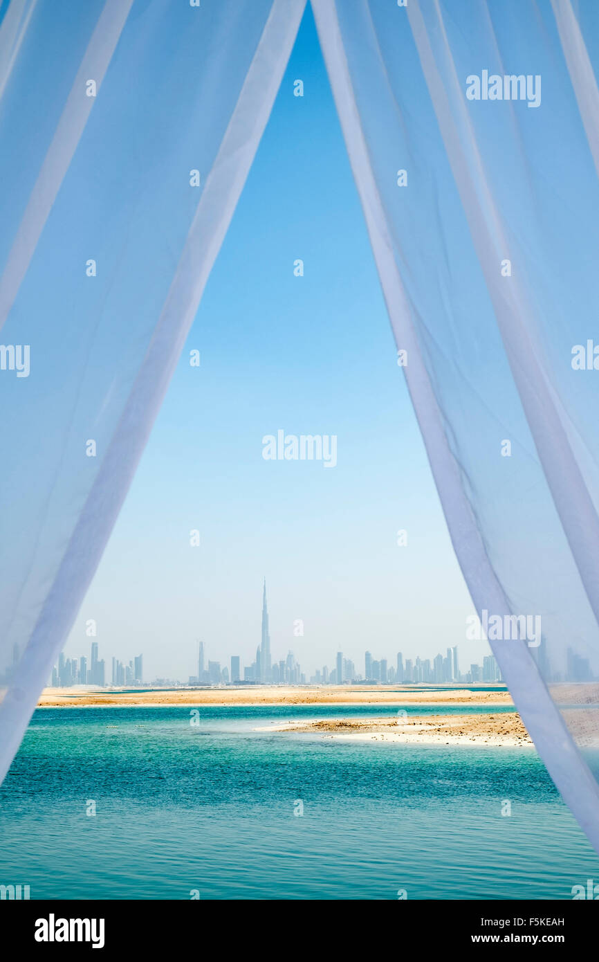 Skyline of Dubai from The Island Lebanon beach resort on a man made island, part of The World off Dubai, United Arab Emirates Stock Photo