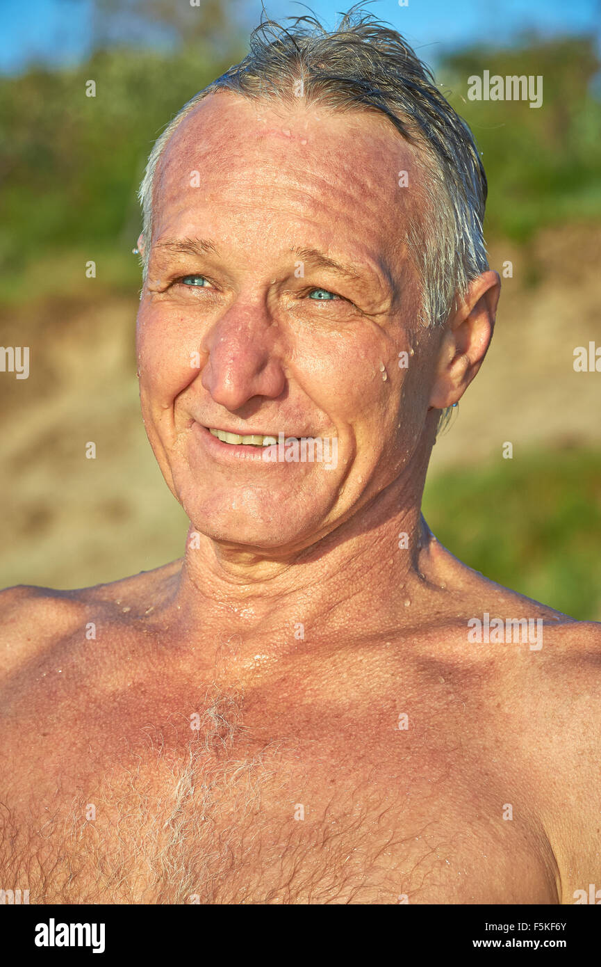 Portrait of a mature aged man with water dripping down his face and shoulders Stock Photo