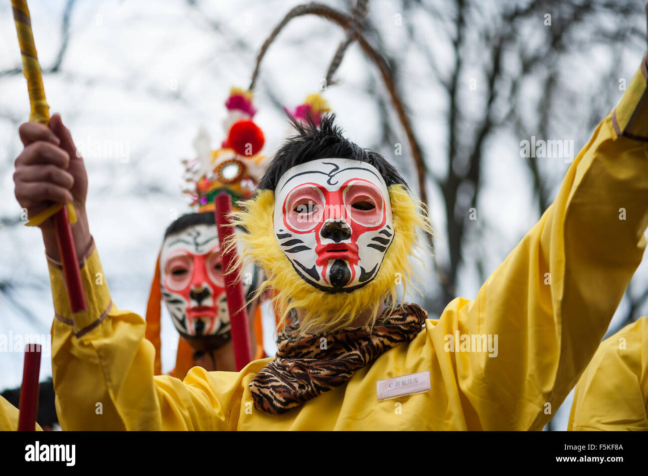 Paris, France - Feb 6, 2011: Chinese performers wearing a monkey mask in traditional costume at the chinese new year parade Stock Photo