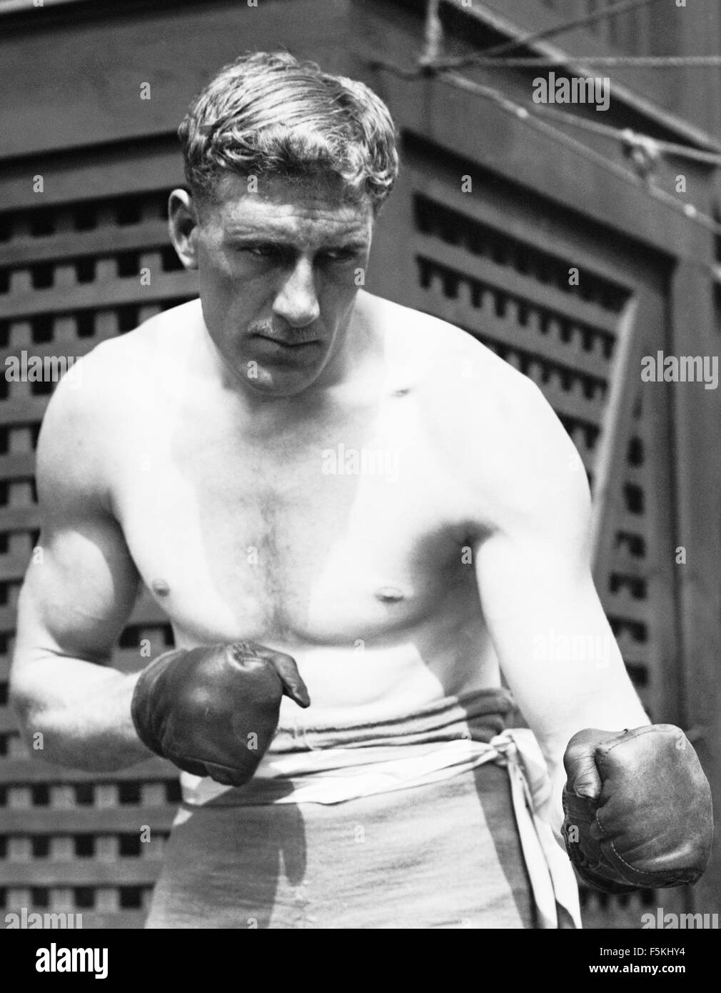 Vintage photo of English heavyweight boxer Bombardier Billy Wells (1889 - 1967). Wells, from the East End of London, was British and British Empire Heavyweight Champion from 1911 to 1919. He was also famous for being an early Rank 'gongman' - the person seen striking the large gong at the beginning of Rank Organisation films. Stock Photo