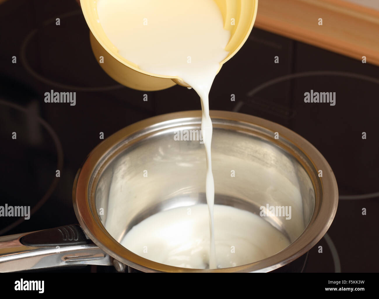 A chef pouring milk. Making Chocolate Cream. Series Stock Photo - Alamy