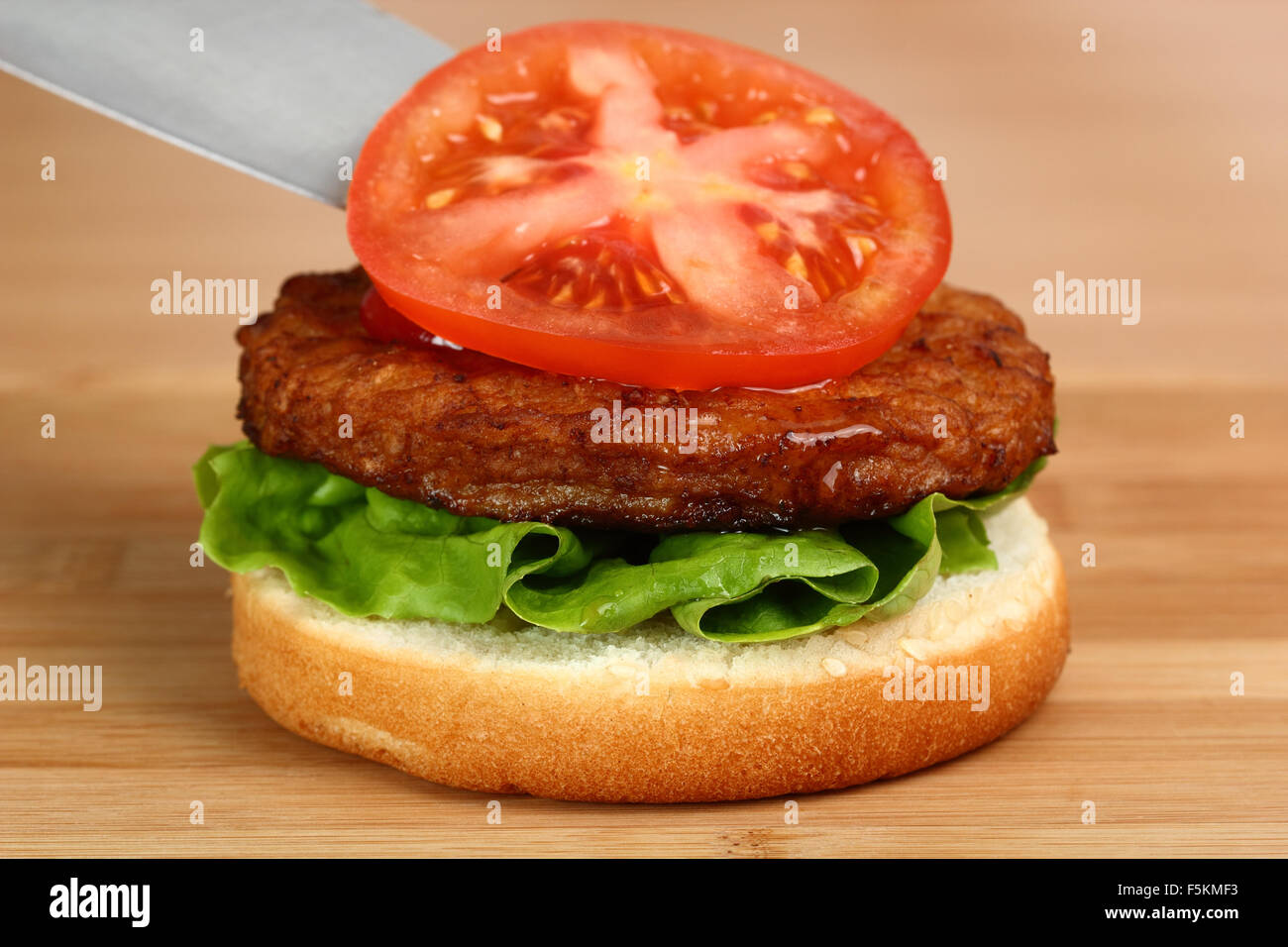 Put Tomato on Patty. Making Hamburger. Macro. Series. 8/12 Stock Photo Alamy