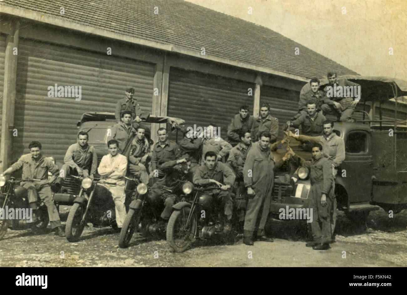 A group of soldiers of the Italian Army with motorcycles and trucks Stock Photo