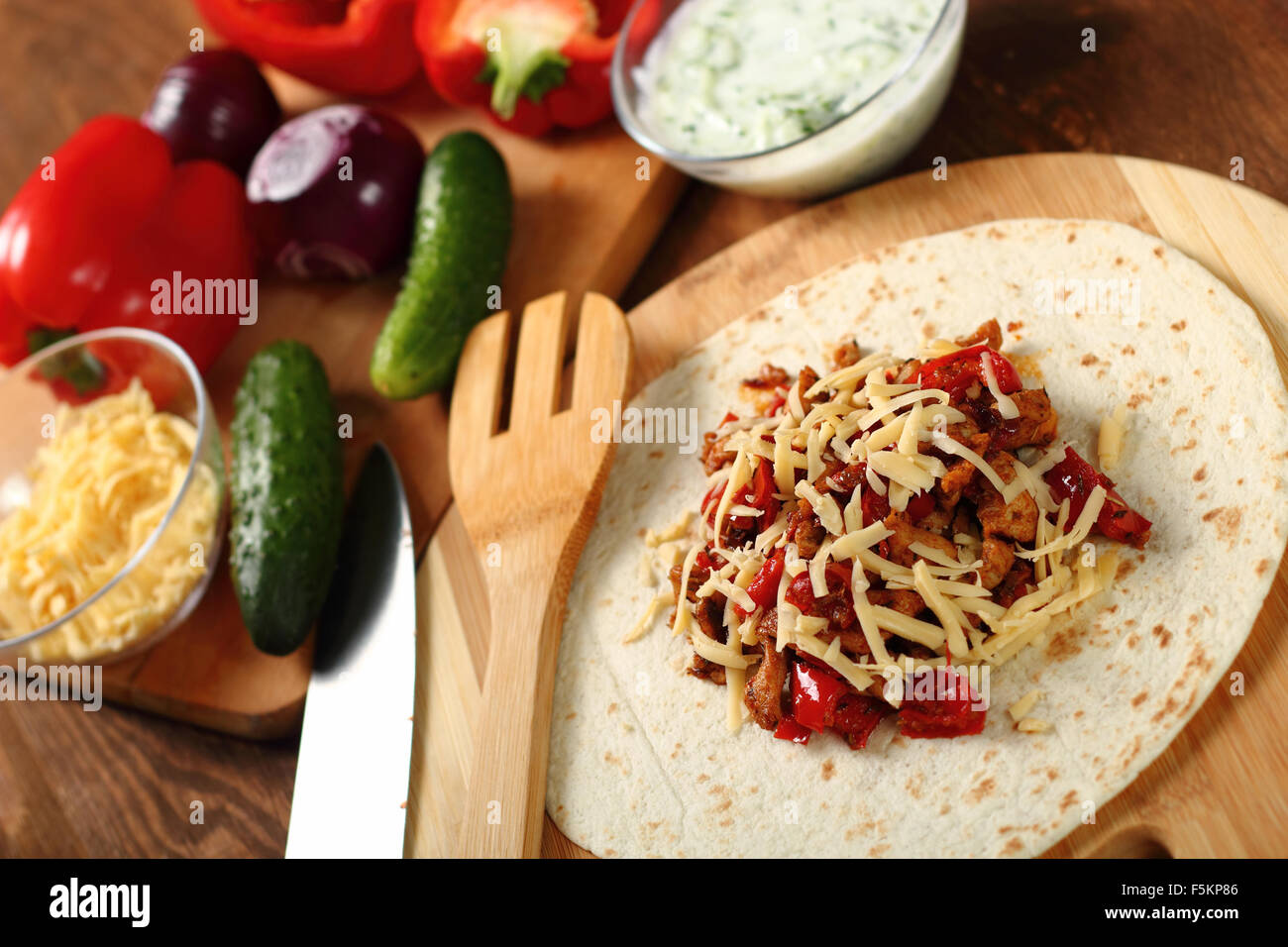 Making Tortilla with chicken and bell pepper. Series. Stock Photo