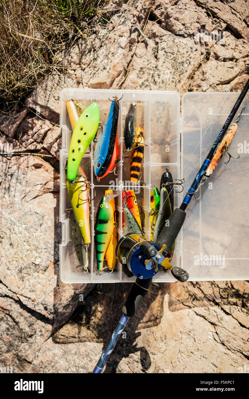 Sweden, Box of fishing tackles and fishing rod on rock Stock Photo - Alamy