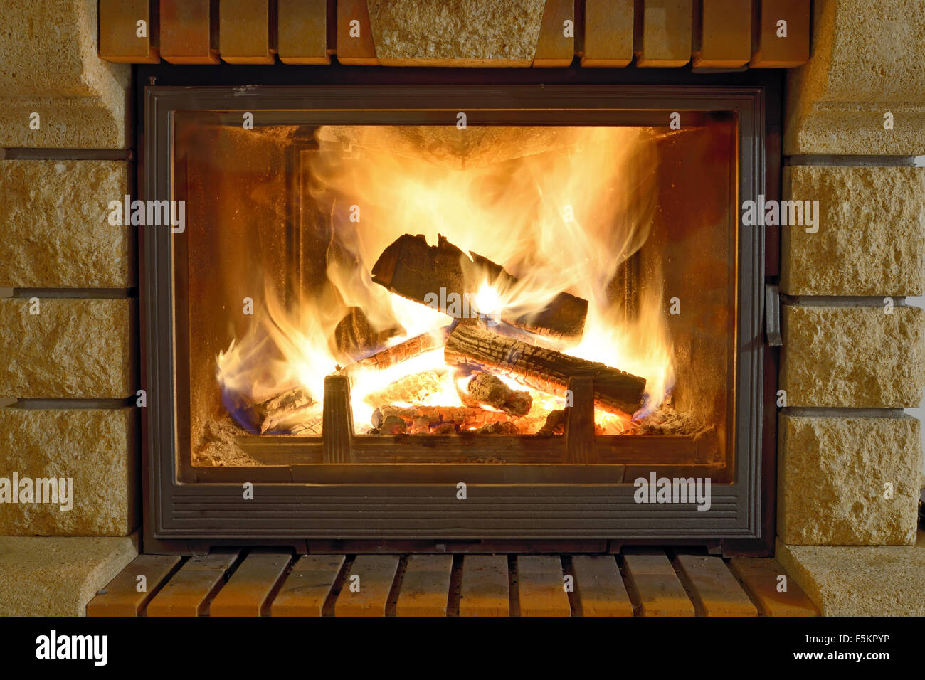 Burning Fireplace in winter time Stock Photo