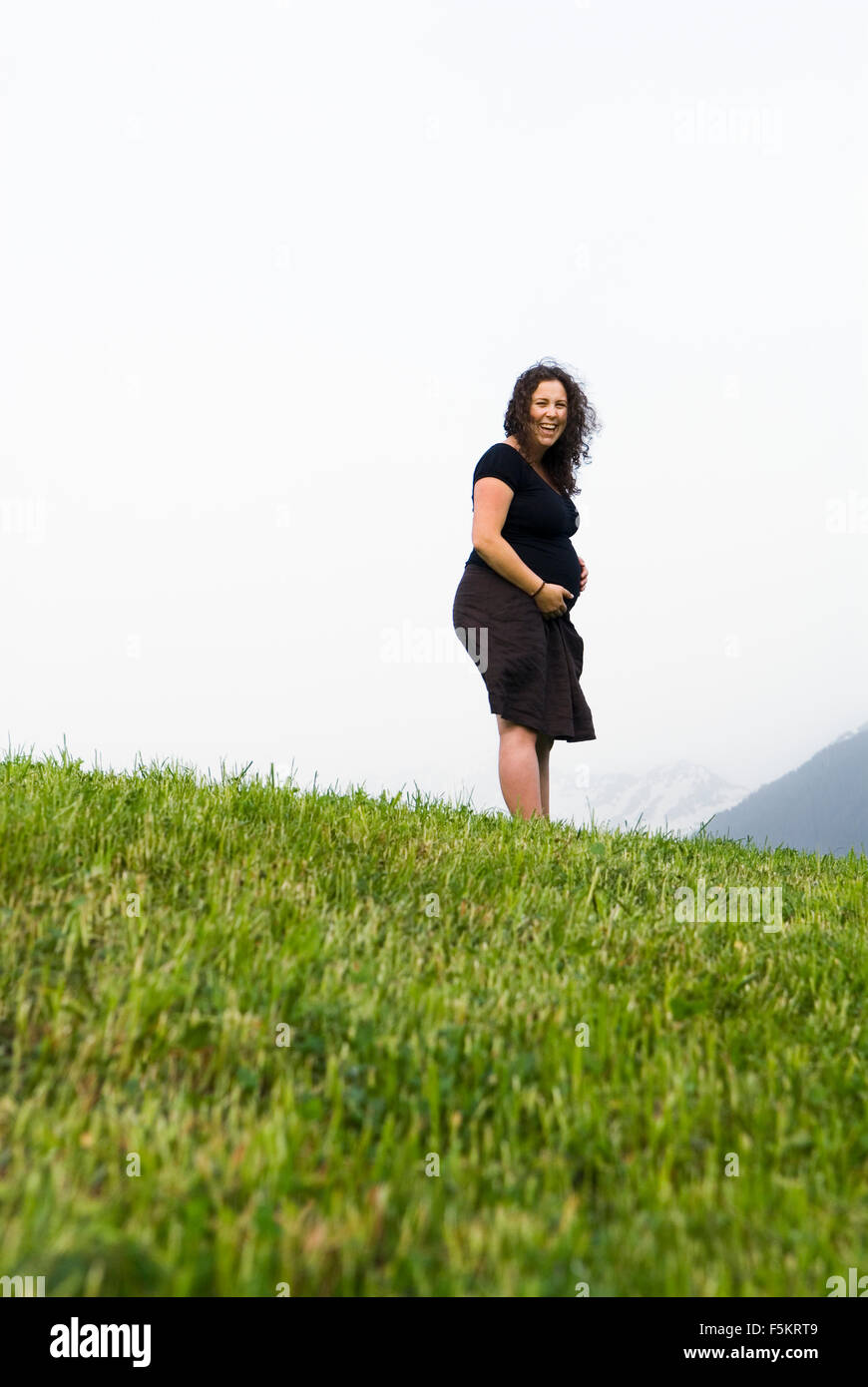 Austria, Vorarlberg, Pregnant woman standing on hill Stock Photo - Alamy