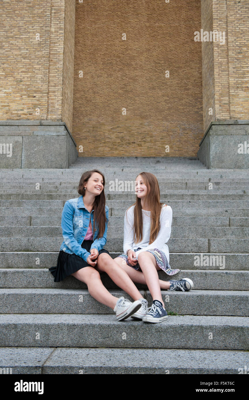 Sweden, Vastra Gotaland, Gothenburg, Gotaplatsen, Teenage girls (14-15) sitting on steps Stock Photo