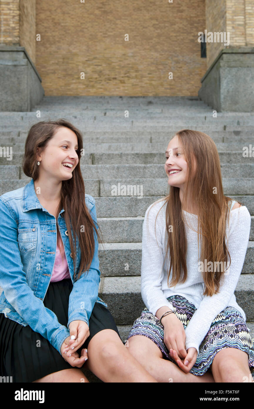 Sweden, Vastra Gotaland, Gothenburg, Gotaplatsen, Teenage girls (14-15) sitting on steps Stock Photo